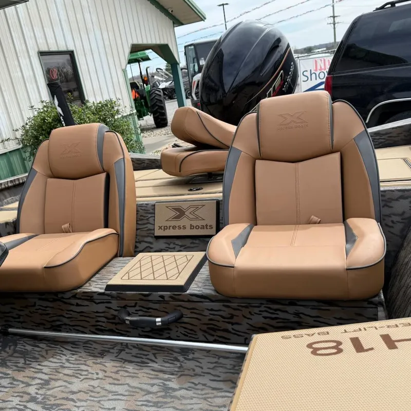 Slide: The Image of 2025 Xpress H18 Bass boat with tan seats and sleek design. - 7