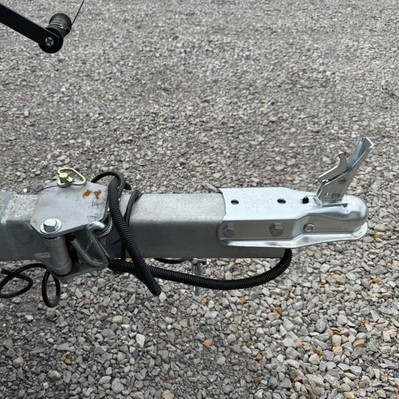 Slide: The Image of Trailer hitch of 2025 Xpress H18 Bass boat on gravel surface. - 8