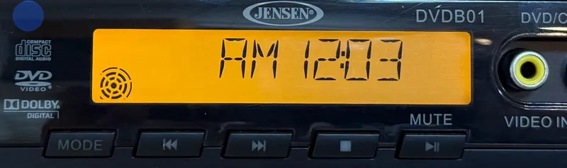 Slide: The Image of Jensen DVD player display showing "AM 12:03" in a 2008 Larson 310 Cabrio. - 18