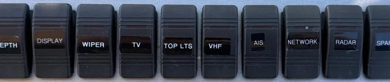 Slide: The Image of Control panel switches on a 2008 Larson 310 Cabrio boat dashboard. - 23
