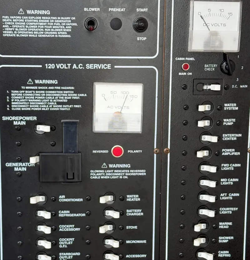 Slide: The Image of Control panel of a 2008 Larson 310 Cabrio boat with various switches and gauges. - 26