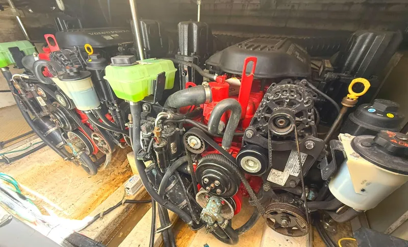 Slide: The Image of Engine compartment of a 2008 Larson 310 CABRIO boat, showcasing dual engines and components. - 27