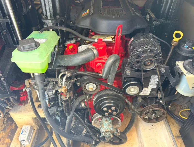 Slide: The Image of Engine compartment of a 2008 Larson 310 CABRIO boat, showcasing mechanical components. - 28