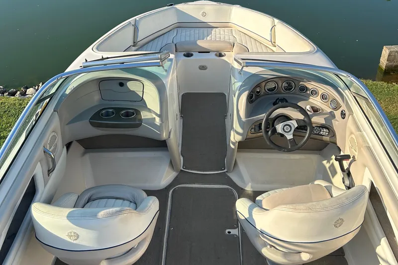 Slide: The Image of Interior of a 2006 Bryant 219 boat with steering wheel and seating. - 5