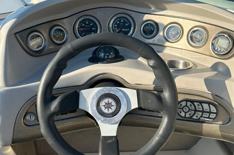 Slide: The Image of Steering wheel and dashboard of a 2006 Bryant 219 boat. - 7