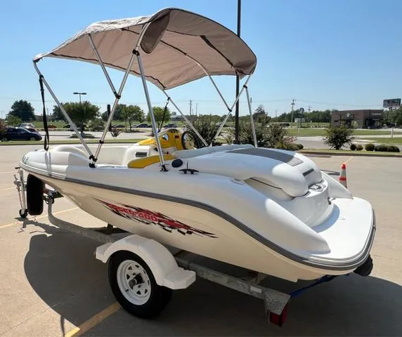 Slide: The Image of 2004 Sea-Doo Sportster LE DI boat with canopy on trailer in parking lot. - 11