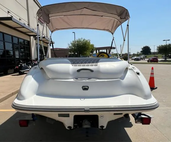 Slide: The Image of 2004 Sea-Doo Sportster LE DI boat with canopy, parked outdoors. - 12