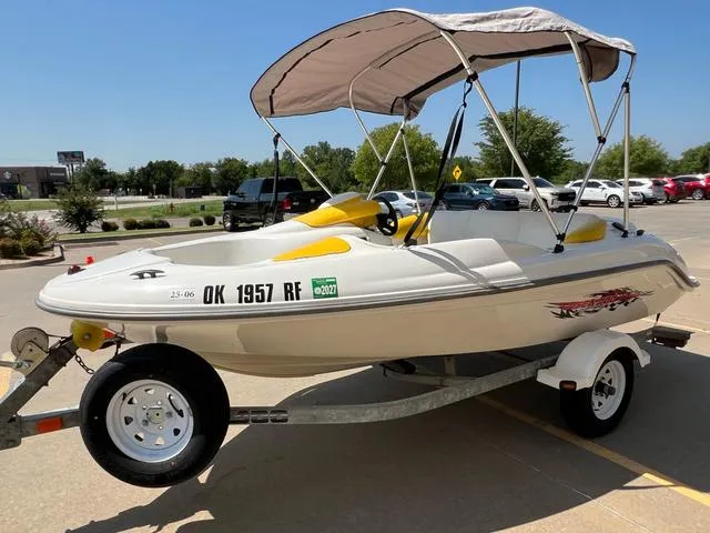 Slide: The Image of 2004 Sea-Doo Sportster LE DI boat on trailer with canopy in parking lot. - 9