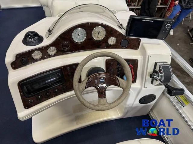 Slide: The Image of Steering console of a 2002 Godfrey 220 DF Pontoon with gauges and controls. - 18