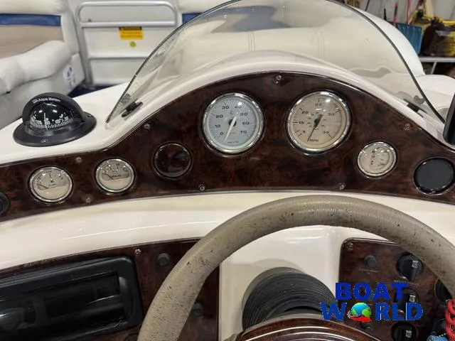 Slide: The Image of Dashboard of a 2002 Godfrey 220 DF Pontoon boat with gauges and compass. - 19