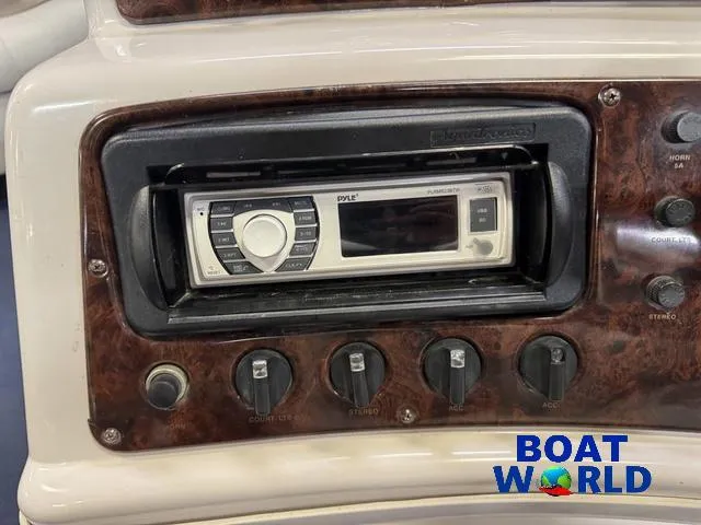 Slide: The Image of 2002 Godfrey 220 DF Pontoon dashboard with stereo system and control knobs. - 20