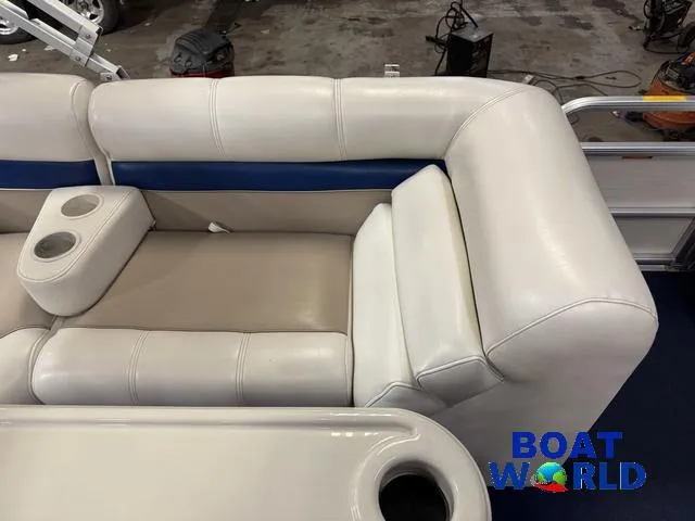 Slide: The Image of White and beige seating on a 2002 Godfrey 220 DF Pontoon boat, featuring cup holders. - 26
