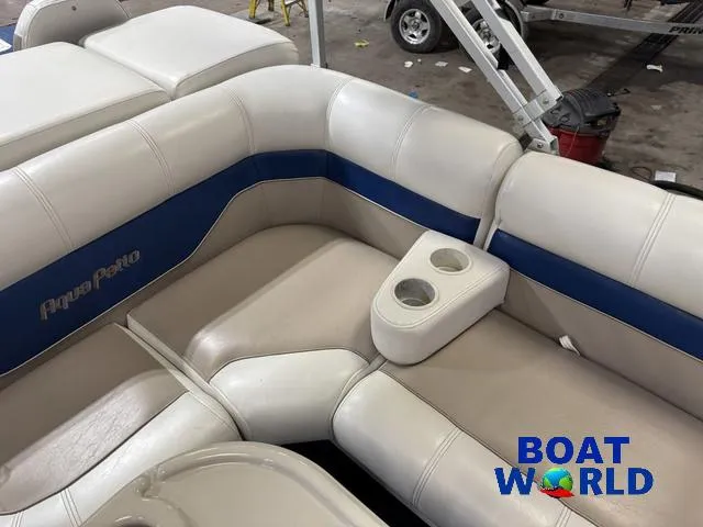 Slide: The Image of 2002 Godfrey 220 DF Pontoon boat interior with white and blue seating, cup holders. - 27