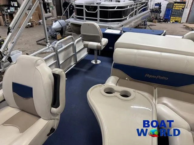 Slide: The Image of 2002 Godfrey 220 DF Pontoon interior with beige seating and blue accents in a showroom. - 29