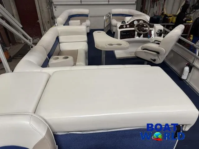 Slide: The Image of 2002 Godfrey 220 DF Pontoon boat interior with white seating and control console. - 3