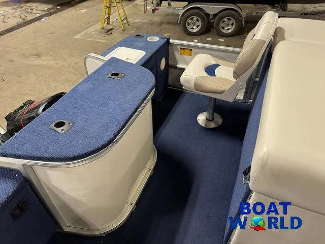 Slide: The Image of 2002 Godfrey 220 DF Pontoon interior with blue carpet and seating. - 33