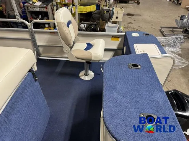 Slide: The Image of 2002 Godfrey 220 DF Pontoon interior with blue carpet and seating, displayed at Boat World. - 34
