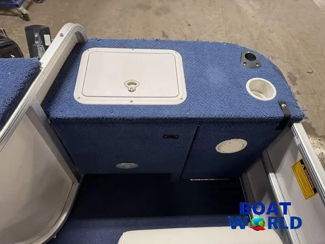 Slide: The Image of 2002 Godfrey 220 DF Pontoon interior with blue carpet and storage compartment. - 36