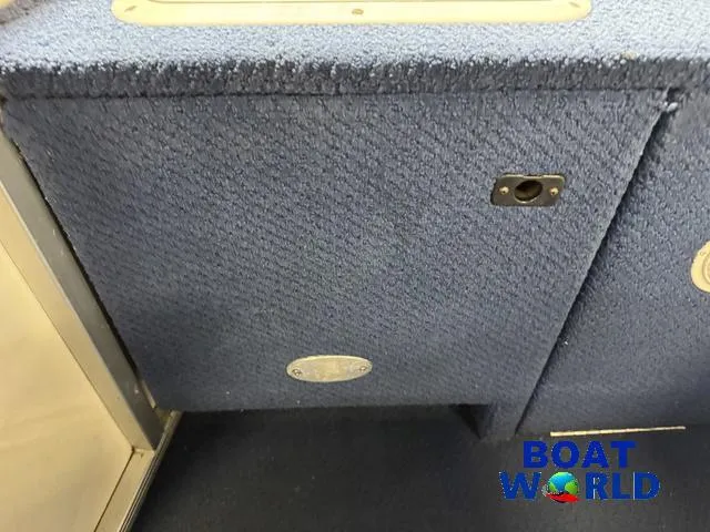 Slide: The Image of 2002 Godfrey 220 DF Pontoon interior with blue carpeted paneling. - 38