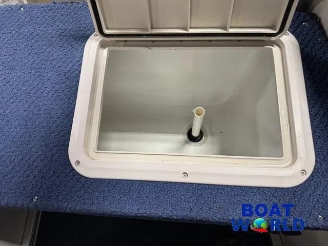 Slide: The Image of Open storage compartment on 2002 Godfrey 220 DF Pontoon boat with blue carpet. - 41