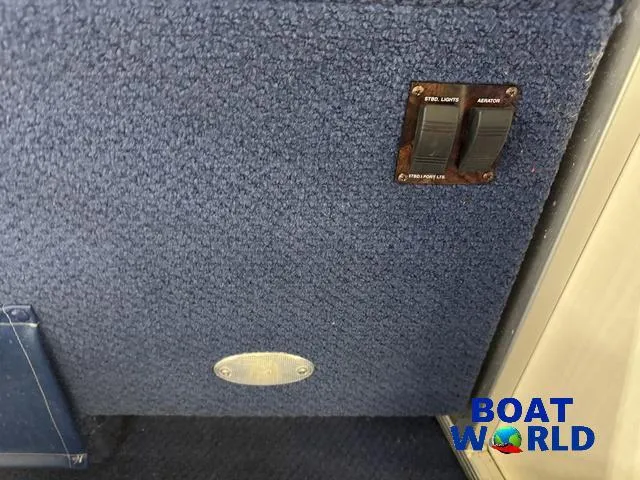 Slide: The Image of Control panel on 2002 Godfrey 220 DF Pontoon boat with switches and carpeted surface. - 42