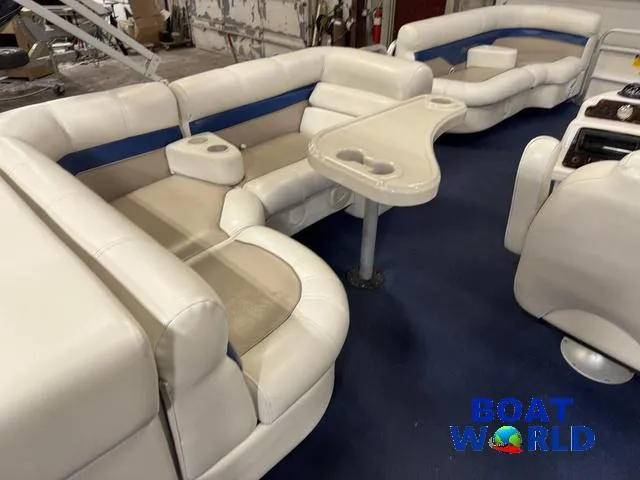 Slide: The Image of 2002 Godfrey 220 DF Pontoon interior with beige seating and blue accents. - 46