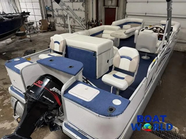 Slide: The Image of 2002 Godfrey 220 DF Pontoon boat with Mercury 50 outboard motor in a garage. - 7