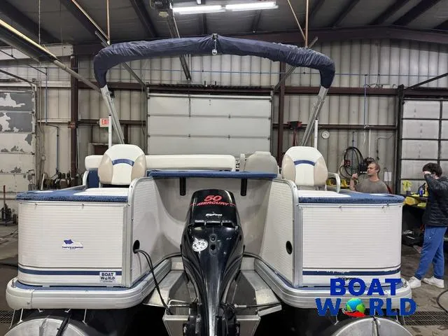 Slide: The Image of 2002 Godfrey 220 DF Pontoon boat in a workshop setting. - 8