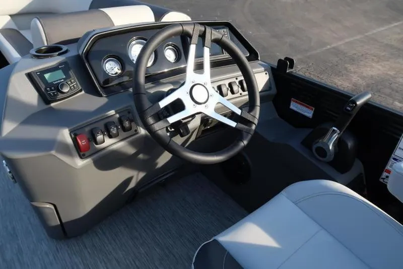 Slide: The Image of 2025 Bennington 22 SSB boat dashboard with steering wheel and control panel. - 16