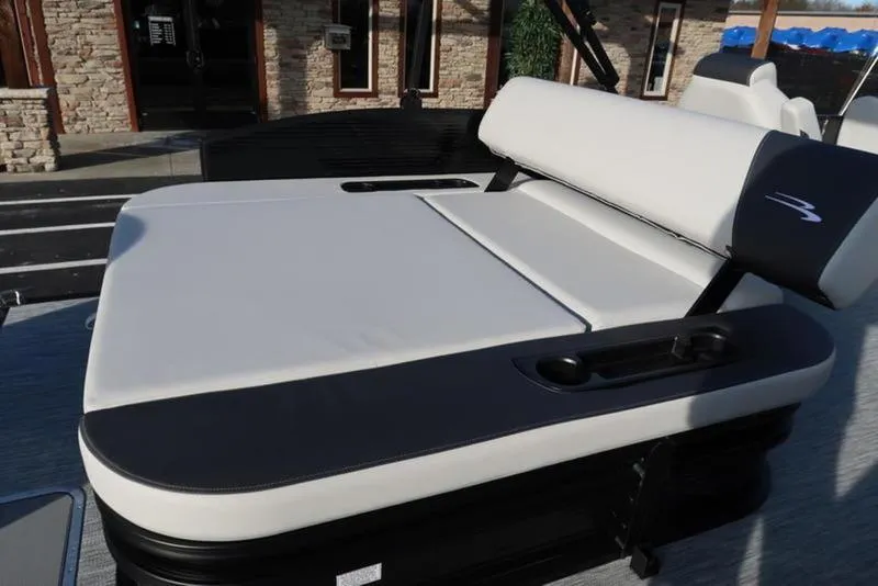 Slide: The Image of 2025 Bennington 22 SSB boat seat with cup holders, outdoor setting. - 22