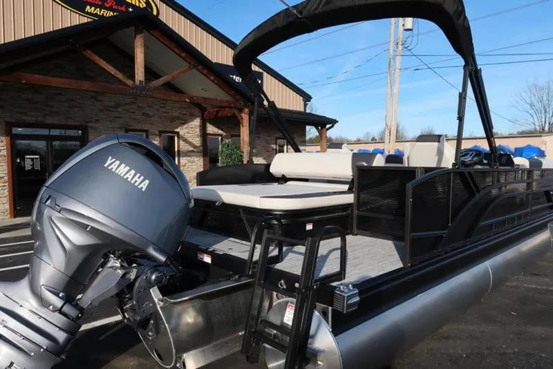 Slide: The Image of 2025 Bennington 22 SSB pontoon boat with Yamaha engine, parked outside a dealership. - 3
