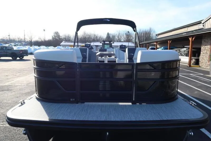 Slide: The Image of 2025 Bennington 22 SSB pontoon boat, front view, parked outdoors. - 8