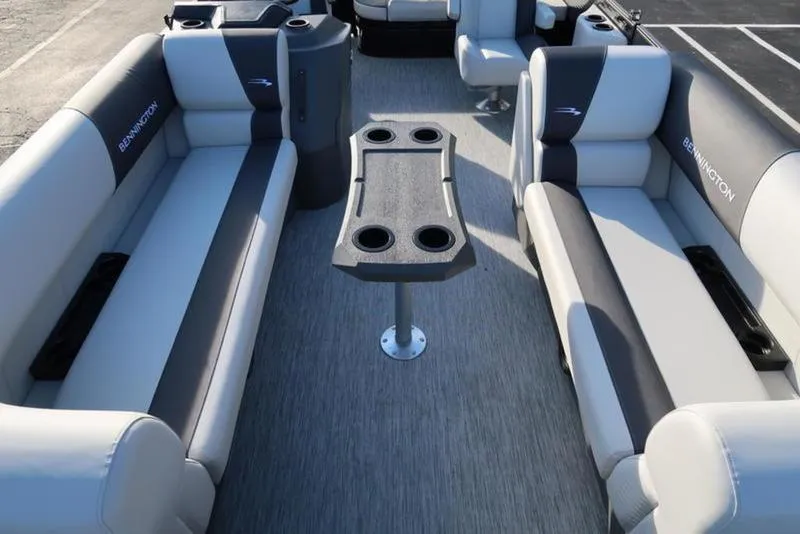 Slide: The Image of 2025 Bennington 22 SSB pontoon boat interior with gray seating and central table. - 9