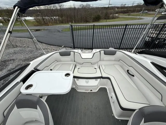Slide: The Image of 2020 Yamaha Boats SX190 interior with seating and table, showcasing spacious design. - 12