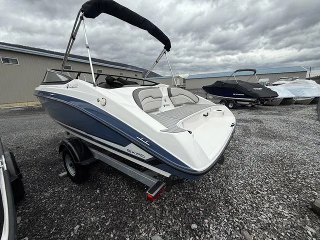 Slide: The Image of 2020 Yamaha Boats SX190 on trailer, parked outdoors under cloudy skies. - 3