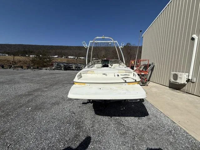 Slide: The Image of 2006 Stingray 195LR boat parked outdoors near a metal building. - 3