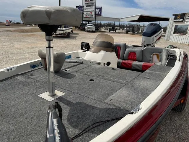 Slide: The Image of 1994 Stratos 201 PRO fishing boat with seating and motor, parked outdoors. - 7