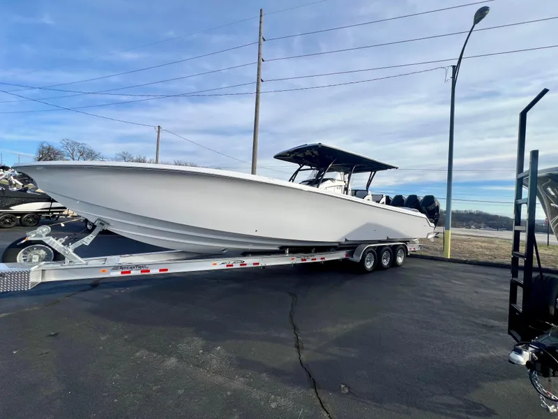 Slide: The Image of 2025 Nor-Tech 390 Sport Center Console boat on trailer, parked outdoors. - 1