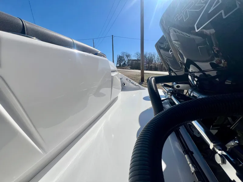 Slide: The Image of 2025 Nor-Tech 390 Sport Center Console boat, close-up of sleek design and powerful engine. - 12