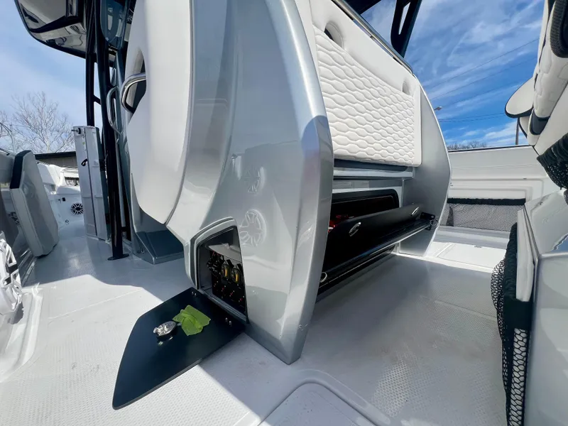 Slide: The Image of 2025 Nor-Tech 390 Sport Center Console interior with open storage compartments. - 25