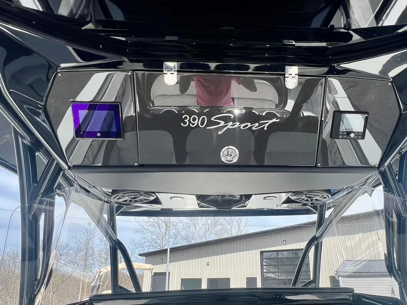 Slide: The Image of 2025 Nor-Tech 390 Sport Center Console, sleek design with modern features, outdoor setting. - 28