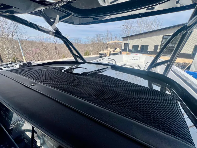 Slide: The Image of 2025 Nor-Tech 390 Sport Center Console boat dashboard with outdoor view. - 29