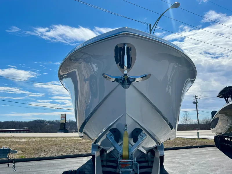 Slide: The Image of 2025 Nor-Tech 390 Sport Center Console boat, front view, under clear blue sky. - 3