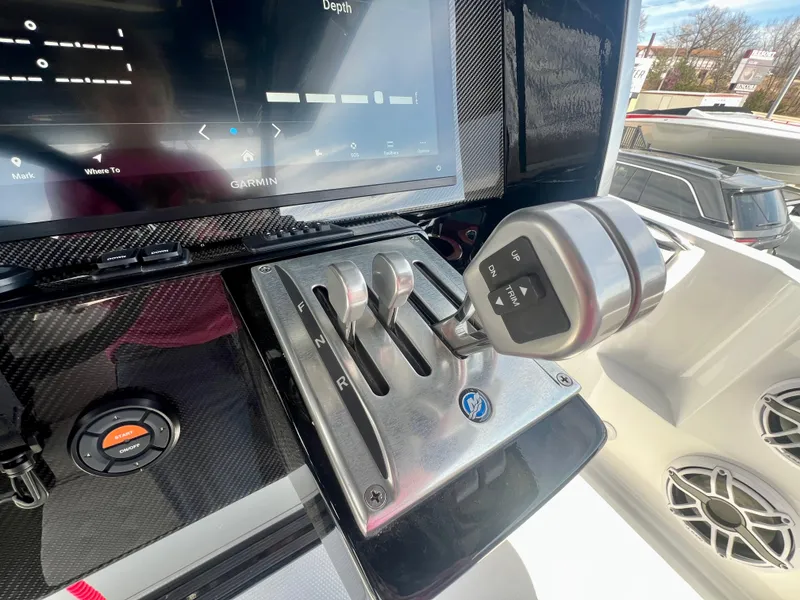 Slide: The Image of Control panel of 2025 Nor-Tech 390 Sport Center Console boat with throttle levers. - 33