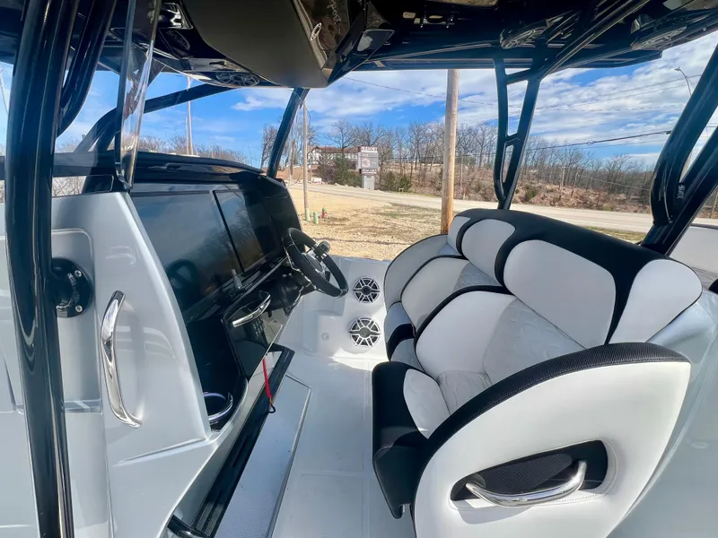 Slide: The Image of 2025 Nor-Tech 390 Sport Center Console interior with sleek black and white seating and modern dashboard. - 36