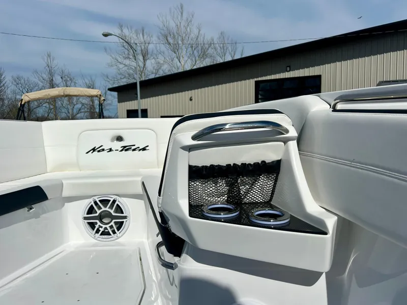 Slide: The Image of 2025 Nor-Tech 390 Sport Center Console interior with cup holders and speaker. - 45