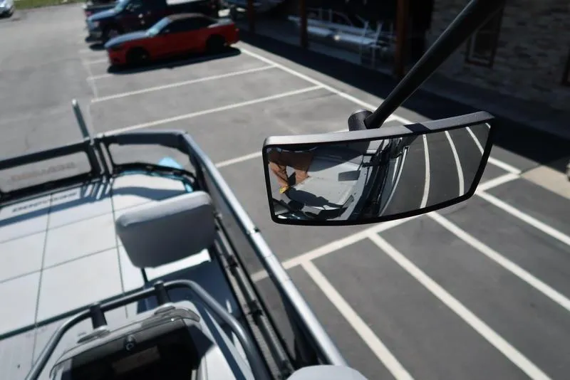 Slide: The Image of 2023 Sea-Doo Switch® Sport 21-230 hp boat with rearview mirror in parking lot. - 30