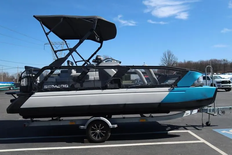 Slide: The Image of 2023 Sea-Doo Switch® Sport 21-230 hp Galvanized boat on trailer, parked outdoors. - 7