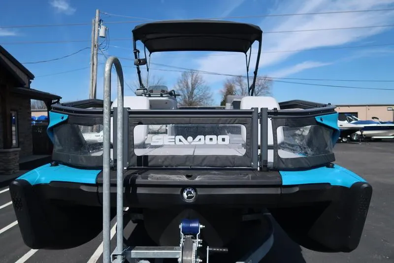 Slide: The Image of 2023 Sea-Doo Switch® Sport 21-230 hp Galvanized boat, rear view, parked outdoors. - 8