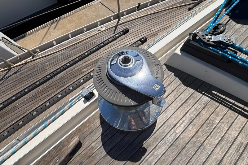 Slide: The Image of Winch on deck of 1994 Nautor Swan 46 MK II sailboat, featuring teak wood finish. - 10